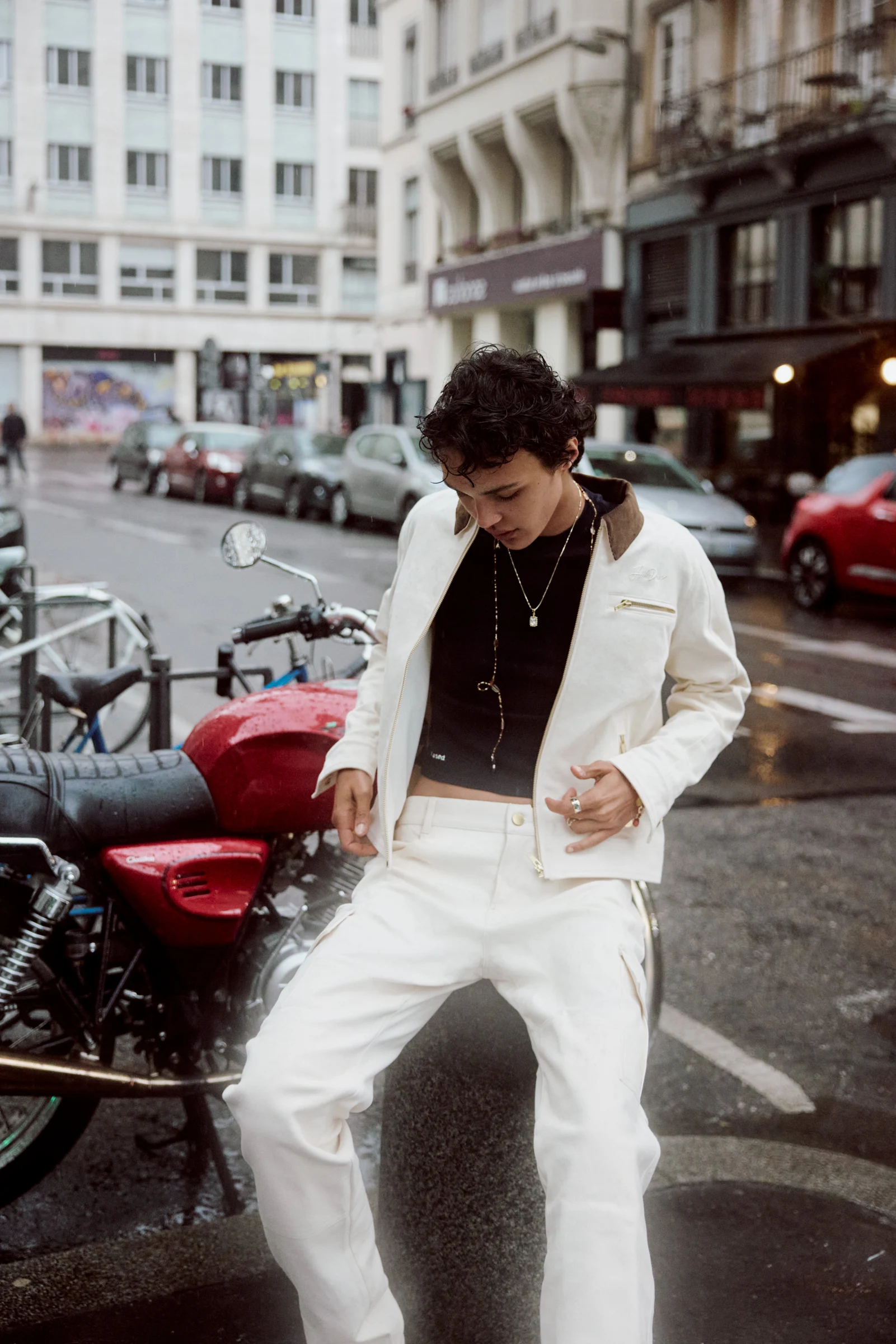 HillsDew white jacket styled in the city beside a motorcycle