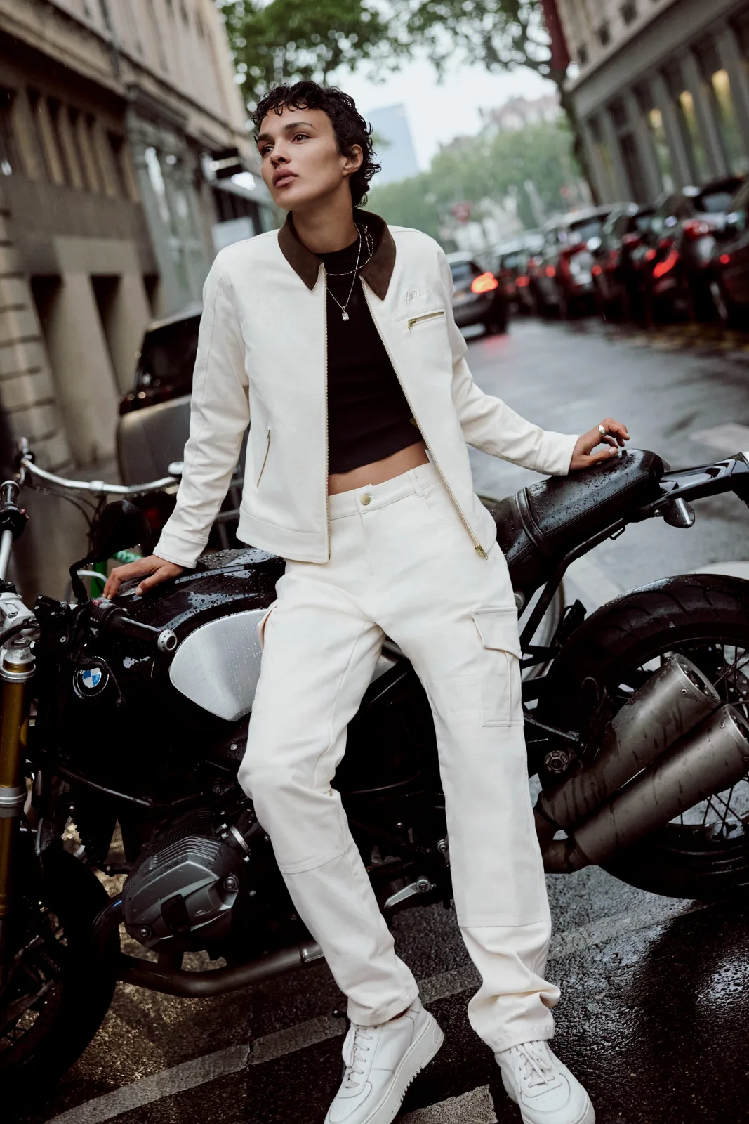 White-on-white styling beside a parked motorcycle.